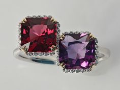 New design in our Decouture collection - Duo of cushion cut Rhodolite Garnet and Amethyst set with diamonds and white gold. Looks like a stack of two rings on your finger (without the mess of constant rotating and scratching!).  SS Diamonds G/SI BR 0.090ct/38pc  CS Rhodolite Garnet CUS 1.940ct/1pc   CS Amethyst CUS 1.500ct/1pc  Modern, yet classic, design, natural high-quality gemstones at very reasonable price. Other gemstones would be added in separate listings. Please contact us for a specific pair of gems - like yours and your partner's  birthstones (a very romantic gift for your anniversary). Please order any size and state the desired one, ideally together with your finger circumcision in mm, in the comment. Free shipment by Fedex Luxury Cushion Cut Gemstones With Prong Setting, Luxury Cushion Cut Gemstones For Wedding, Luxury Amethyst Cushion Cut Ring For Formal Occasions, Luxury Amethyst Cushion Cut Ring For Formal Events, Luxury Cushion Cut Amethyst Ring For Formal Occasions, Luxury Cushion Cut Amethyst Ring For Anniversary, Amethyst Set, Two Rings, Amethyst And Diamond Ring