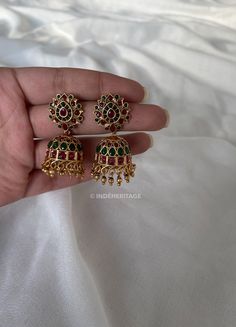 Step into the world of timeless elegance with our Jhumka Earrings. These exquisite earrings are a perfect blend of traditional design and contemporary style, making them a must-have accessory for any occasion. The jhumka style is inspired by traditional South Indian jewelry, known for its intricate craftsmanship and ornate designs. These earrings beautifully capture the essence of Indian culture and heritage, making them a timeless treasure to cherish. Whether you're attending a wedding, festival, or any special event, these Jhumka Earrings will complement your traditional attire flawlessly. They are also versatile enough to add a touch of elegance to your everyday look, making them a versatile addition to your jewelry collection. --------------------------------------------------------- C Bridal Temple Jewellery, Indian Culture And Heritage, Traditional Indian Jewellery, South Indian Jewelry, South Indian Jewellery, Indian Culture, Indian Earrings, Traditional Attire, Jhumka Earrings