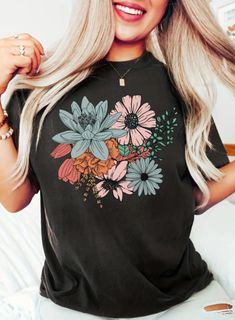 Elevate your wardrobe with our charming Women's Floral Print T-Shirt, blooming with elegance and style. Embrace the beauty of nature with a delicate floral pattern that adds a touch of femininity to any outfit. Crafted from soft, breathable fabric, this tee ensures comfort throughout the day. Perfect for casual weekends, brunch dates, or relaxing at home, it pairs effortlessly with jeans, shorts, or skirts. Available in a range of sizes and vibrant floral designs, it's a versatile staple that co Trendy Floral Print Crew Neck T-shirt, Trendy Spring Tops With Plant Print, Trendy Plant Print Tops For Spring, Trendy Tops With Plant Print For Spring, Relaxed Fit Floral Print T-shirt For Spring, Multicolor Floral Print T-shirt For Spring, Green Tops With Plant Print For Spring, Trendy Floral Print Short Sleeve T-shirt, Spring Multicolor Floral Print T-shirt