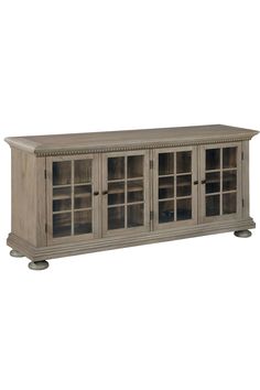 a large wooden cabinet with glass doors on the front and bottom shelves in grey wood