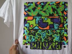 "Vintage Bali Barrel T Shirt Vintage Surf Wear 90s Beach Wear 90s Tropical Graphic Single Stitch Surfing t Shirt Surf fashion o Size armpit to armpit 19.5\" top to botton 28\" shoulder width 19\" (inch) o Fabric cotton 100% made in U.S.A. o Condition great vintage condition 8.5/10 oo If you are in any interested and have any questions? Please do ask me on various details, I am more than happy to help oo \" Shipping Wordwide\" registered airmail thailand post (small package) receiving the item Wi Green Hawaiian Graphic Print Tops, Multicolor Hawaiian Graphic Print T-shirt, Green Cotton Hawaiian T-shirt, Green Hawaiian Cotton T-shirt, Tropical Multicolor Graphic Print T-shirt, Tropical Multicolor Graphic T-shirt, Vintage Surf Wear, Stitch Surfing, 90s Beach