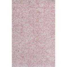 a rug with pink and white speckles on the bottom, in front of a white