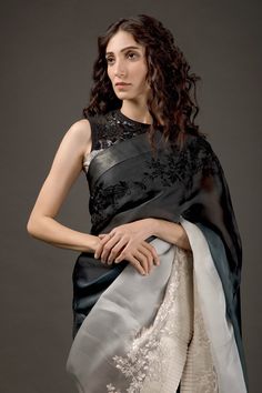 Black and ivory two tone ombre organza saree with resham thread and hand embroidery work. Comes with plain chanderi silk blouse fabric and satin underskirt.
Component: 3
Pattern: Embroidered
Type Of Work: Resham Thread Work
Fabric: Saree: Organza, Blouse Piece: Chanderi Silk
Color: Black, Ivory
Other Details: 
Floral motifs
Pleated hem
Note: The blouse worn by the model is not for sale
Occasion: Reception - Aza Fashions Evening Blouse With Sheer Dupatta In Organza, Evening Organza Blouse With Sheer Dupatta, Evening Organza Blouse Piece With Intricate Embroidery, Evening Blouse With Sheer Dupatta In Tissue Silk, Elegant Evening Chanderi Saree, Evening Saree With Resham Embroidery In Organza, Evening Tissue Silk Saree With Resham Embroidery, Evening Organza Saree With Resham Embroidery, Elegant Unstitched Organza Blouse Piece