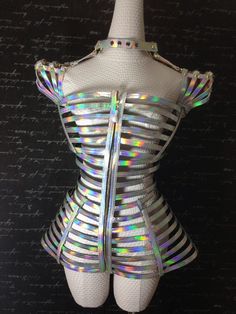 a white mannequin with silver holographics on it's back