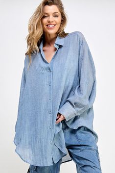 Relaxed Fit Long Sleeve Top With Rolled Sleeves, Blue Tops With Roll-up Sleeves And Spread Collar, Blue Top With Roll-up Sleeves And Spread Collar, Casual Light Wash Blouse With Button Closure, Relaxed Fit Button-up Top With Rolled Sleeves, Relaxed Fit Light Wash Shirt With Buttons, Solid Tops With Roll-up Sleeves And Shirttail Hem, Oversized Light Wash Button-up Top, Relaxed Fit Light Wash Top With Buttons