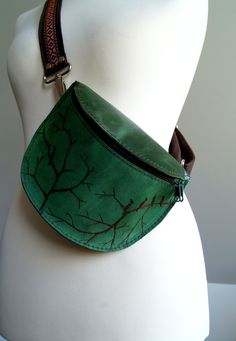 Practical hip bag made of natural leather (various textures and shades of green). A small but roomy, fits phone, wallet, tissues, etc. Inside two compartments. Sold complete with an adjustable leather strap with Aztec pattern ribbon (max.110cm -43''). You can wear it on the shoulder. Dimensions: 21 / 17cm (8,26/6,69inches) Ready to send. Bags are sewn in a small studio in Poland, with the highest quality cow leather and other top-quality materials. These are single copies, or short series. When you buy a our bag you are guaranteed that you purchase the item unique and great quality. Please contact me if you want to change some detail, such as color, or anything else. We are happy to personalize a bag for you.  If you want to determine the cost of shipping to your country.  You can pay by b Green Crossbody Belt Bag With Removable Pouch, Green Rectangular Belt Bag For Travel, Green Belt Bag With Adjustable Strap, Green Everyday Belt Bag With Adjustable Strap, Green Belt Bag With Adjustable Strap For Everyday, Green Crossbody Belt Bag With Cell Phone Pocket, Green Casual Pouch Belt Bag, Casual Green Pouch Belt Bag, Green Belt Bag With Removable Pouch