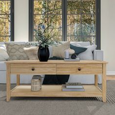 a living room scene with focus on the coffee table and sofa in the foreground