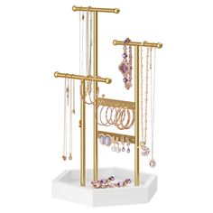 a gold jewelry rack with lots of necklaces and rings hanging from it's sides