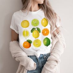 This cute cottagecore shirt features a variety of vintage citrus. This trendy design will your new favorite shirt that you reach for again and again. Makes a great gift for any lemon, lime and orange lover. * Q U I C K * F A C T S * ♥ Solid colors are 100% cotton ♥ Heather colors are cotton/poly blend ♥ Design is high quality digital print ♥ Wash and dry normally (on cool for best results) * S I Z I N G * ♥ Sizing is unisex so runs like men's, though not overly large ♥ Most women find their typi Cute White Tops With Fruit Design, White Short Sleeve T-shirt With Lemon Print, Cute White Fruit Design Tops, Casual Lemon Tops For Summer, Short Sleeve Lemon Print Graphic Tee, White Short Sleeve Top With Lemon Print, White Crew Neck T-shirt With Lemon Print, White Lemon Print T-shirt For Summer, Casual White Tops With Fruit Design