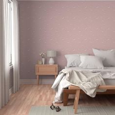 a bedroom with pink walls and white bedding