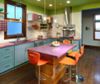 a blurry image of a kitchen with an island table and chairs in the center