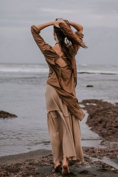 The Dragonfly blouse, a loose-fitting long sleeve top with an asymmetrical hemline and a scoop neckline is the perfect shirt for layering. Soft feather weight organic cotton makes it comfy while the brown colour dyed with organic dyes gives it a bohemian finish. This blouse is so versatile that you can dress it up or wear it casual, over leggings or jeans. ♡ FABRIC DETAILS ♡ Soft feather weight organic cotton sustainably dyed Our experience showed that customers keep coming back to our shop not Boho Tops For Women, Long Brown Skirt, Boho Wear, Cotton Maxi Skirts, Bohemian Skirt, Maxi Skirt Boho, Organic Cotton Dress, Organic Dyes, Brown Skirts