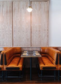 a booth with two tables and some chairs