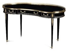 a black and gold console table with two drawers on one side, an oval shaped mirror top