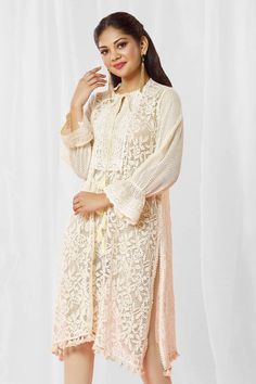 Ivory kurta with ecru floral lace base and scalloped lace bodice. 
Components: 1
Type Of Work: Lace
Neckline: Tie-up
Sleeve Type: Bell
Fabric: Lace
Color: Ivory
Other Details: 
Closure: Kurta: Front drawcord
Note: Churidar worn by the model is not for sale
Occasion: Puja,Mehendi and Haldi - Aza Fashions Lace Kurta, Kurta For Women, Lace Neckline, Fashion App, Churidar, Lace Bodice, Scalloped Lace, Color Ivory, Aza Fashion