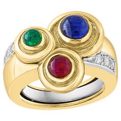 Presenting the Vintage Hammered 18K Gold Bubble Ring, featuring a stunning arrangement of Ruby, Sapphire, Emerald, and Diamond. This exquisite ring is expertly crafted from 18 karat Yellow Gold, ensuring both durability and elegance. The ring weighs 15 grams and is adorned with all-natural stones, including cabochon-cut Rubies, Emeralds, and Sapphires. At its center, the design showcases three round cabochon-cut stones, complemented by six sparkling diamonds that weigh a total of 0.25 carats. Designed by the renowned David Webb, this vintage bubble ring is a size 6, making it a perfect fit for those who appreciate unique and luxurious jewelry. Additionally, a matching earring is available in a separate listing, completing this stunning set. This piece is signed by David Webb, adding to its Diamond Bubble Ring, Luxurious Jewelry, Gold Bubbles, Bubble Ring, Ring Ruby, David Webb, Clover Earrings, Cabochon Ring, Ruby Sapphire