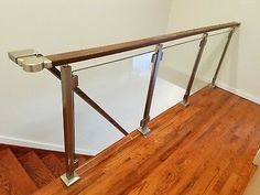 an image of a glass railing on the top of some stairs in a house or apartment