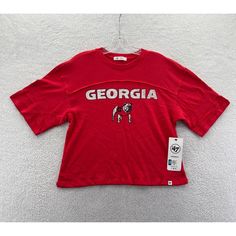 New '47 Brand Georgia Bulldogs Uga Crop Top T-Shirt Women's Small This Has A Nice Relaxed Draped Fit, You May Be Able To Comfortably Size This Up To A Medium Just Double Check Your Measurements Prior To Purchase New With Tags In Excellent Condition Measurements Are Posted For You To Look At Within The Listing Photos Enjoy Lightning Fast Shipping Message Response Times I Ship Items Every Day, You Can Expect Your Order To Be Sent Out Within 1 Business Day And Tracking Provided Browse Our Store To Red Sporty Tops For College, Sporty Red Tops For College, Collegiate Relaxed Fit Tops For Football Season, Red Varsity Sports Top, Red Varsity Streetwear Top, Red Varsity Top For Streetwear, Collegiate Red Tops With Team Logo, Red Varsity T-shirt For Fan Gear, University Red Varsity Top For Sports Season