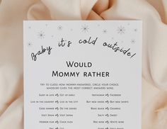 a baby it's cold outside poem is displayed on a white sheeted bed