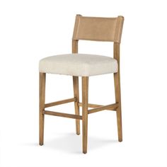 an upholstered bar stool with a beige seat and backrest, against a white background