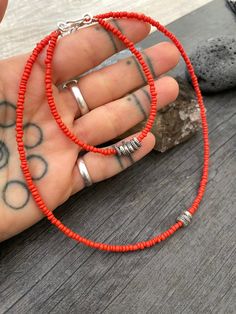 A unique set of dainty seed bead choker and bracelet. A minimalist cottagecore style jewelry made with orange earth tone seed bead, and in the middle unique sterling silver beads with tiny hand stamped plants details on them. This sterling silver beads are spinning beads and they have sterling silver hook clasp. You can choose to buy either just the bracelet just the choker or get both to have a unique set. This are perfect for layering with other accessories and perfectly statement pieces to we Orange Round Beads Jewelry For Everyday, Everyday Orange Round Bead Jewelry, Everyday Spiritual Orange Jewelry, Adjustable Coral Jewelry With Tiny Beads, Everyday Colorful Beads Orange Jewelry, Adjustable Orange Choker Jewelry, Handmade Orange Necklace For Everyday, Minimalist Beaded Heishi Bead Jewelry, Minimalist Hand-strung Beaded Necklaces As Gift