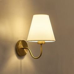 a wall light with a white shade on it