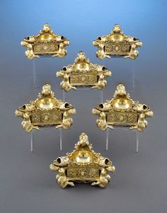 six pieces of gold with designs on them