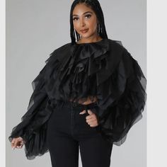 Make A Statement With This Eye-Catching Ruffle Tulle Blouse. Expertly Designed With Plus Sizes In Mind, This Crop Top Features Layers Of Luxurious Tulle Fabric Gathered Together To Create Beautiful Ruffles. The Airy Fabric Is A Perfect Addition To Dressy And Casual Looks Alike, While The Timeless Black Color Makes It Easy To Incorporate Into Any Wardrobe. Take Your Ensemble To The Next Level With This Fashionable Plus Size Blouse. -Plus Size Ruffle Tulle Crop Top Blouse Black -Ruffled Tulle -Cro Chic Ruffled Tops For Evening, Chic Evening Tops With Ruffles, Elegant Black Top With Ruffles, Long Sleeve Ruffled Tops For Night Out, Long Sleeve Ruffle Tops For Night Out, Ruffled Blouse For Night Out In Fall, Fall Ruffled Blouse For Night Out, Black Ruffled Long Sleeve Blouse, Long Sleeve Ruffled Blouse For Night Out