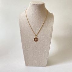 This elegant Star of David pendant features 24 round genuine Bohemian garnets, set in 900 silver with gold vermeil. Measures approx 21mm in length and 18mm in width, not including bale. The item listed here is old stock from a defunct jewelry business. Great condition unless otherwise noted. Please keep in mind that computer monitors vary & I do my best to provide an accurate representation of the colors of the items listed. Please note chain not included. Classic Star-shaped Necklace As Gift, Classic Star-shaped Necklace For Gift, Classic Star Shaped Necklace For Gift, Classic Star Of David Jewelry For Gift, Classic Star Of David Necklace As Gift, Gold Brass Necklace With Star Charm, Elegant Star-shaped Brass Jewelry, Classic Star Of David Necklace For Gift, Brass Star-shaped Jewelry Gift