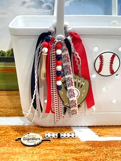 a baseball themed tote bag sitting on top of a wooden floor