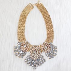 "Looking for the perfect piece that makes a 'look at me' statement? This gold fusion necklace looks perfect paired with a simple white crystal earring. Style it east or style it west! Size Necklace - 10\" + 3\" chain" Gold Jeweled Bib Necklace For Party, Gold Bib Necklace With Jewels For Party, Gold Crystal Bib Necklaces For Party, Gold Crystal Bib Necklace For Party, Elegant Gold Bib Necklace With Rhinestones, Glamorous Gold Rhinestone Necklace, Glamorous Gold Bib Necklace For Party, Wave Necklace, Crystal Statement Necklace