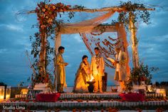 an outdoor wedding setup with candles and flowers