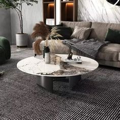 a living room filled with furniture and a large clock on the wall above it's glass top coffee table