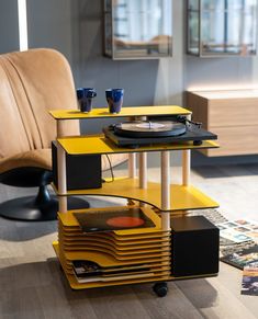 a record player sitting on top of a yellow table