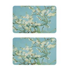 two coasters with white flowers on a blue background, one has an image of the branches