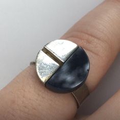 Rare Cool Item Amazing Mid century Modernist ring fashioned in 800 silver and 1/2 moon  black onyx  tile in a simple Geometric Design by renowned  German jewellery Designer Hans Rudi Hofer ring is  signed 800 HH . The band split flat tab ends style band  is adjustable between size US  4.5 to  @ 7 . The ring is in very good vintage condition, weighs 6.67 grams .  Circa 1960 Handmade Modernist Ring, Luxury Brutalist Style Ring, Luxury Modernist Men's Silver Ring, Luxury Brutalist Metal Rings, Modernist Hand-cast Jewelry Ring, Onyx Tile, German Jewelry, Simple Geometric Designs, Modernist Ring