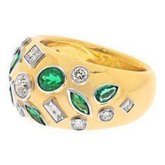 Elegance in Every Detail: Your Emerald and Diamond Wide Band Ring. Indulge in the luxurious beauty of this wide band ring, adorned with bright burnish and bezel-set diamonds and vibrant green emeralds. Whether you wear it as a stylish cigar band or a meaningful anniversary ring, this piece is destined to become a cherished part of your collection. **Emerald Elegance: The Allure of Green Gemstones** Featuring a total carat weight of 1.35 carats in vivid green emeralds, this wide band ring exudes sophistication and timeless charm. The emeralds are like lush leaves in a flourishing garden, making a statement with their enchanting color. **Dazzling Diamonds: Scattered in Brilliance** Accentuating the green emeralds are diamonds with a total carat weight of 1.76 carats, adding a touch of bright Luxury Wide Band Diamond Ring In Yellow Gold, Emerald Cocktail Ring, Emerald Cocktail, Wide Band Ring, Birthday Ring, Diamond Cocktail Rings, Bezel Set Diamond, Contemporary Classic, Wide Band Rings