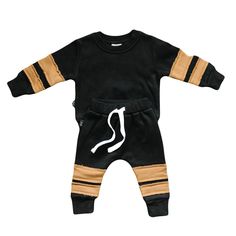 Lennox Jogger Set will ensure your little one is wrapped up in the utmost comfort. This two-piece set is crafted with thick and plush fleece to keep them warm. The raw cut stripes on the arms and legs are striking, and the adjustable drawstring waistband ensures a perfect fit every time. Neutral Clothing, Pajama Romper, Christmas Blankets, Halloween School, Fall Favorites, Jogger Set, Drawstring Waistband, Summer Collection, Little One