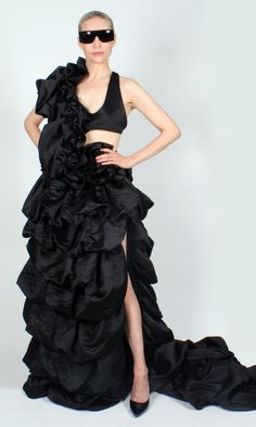 OR 4 interest-free installments of $200.00 USD by Dramatic black gown in gathered satin-finish fabric. One of a kind. Custom made by DOPE Tavio. Sizing: Fully adjustable design. Halter neckline, center back, and waist can all be let in/out to accommodate most sizes S-XL Dry clean only. Party Gown With Ruched Bodice In Taffeta, Taffeta Gown With Ruched Bodice For Party, Taffeta Evening Dress With Ruffles For Gala, Evening Taffeta Gown With Ruched Bodice, Taffeta Evening Dress With Ruffles For Party, Fitted Black Taffeta Gown, Black Fitted Taffeta Gown, Voluminous Gown For Gala, Voluminous Evening Dress