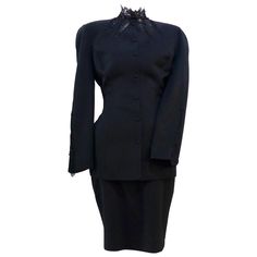 This THIERRY MUGLER skirt suit is composed of a black polyester and lace fabric. Features a classic Mugler silhouette with nipped waist and curved bust-line to neckline design. The jacket has front snap closures, rounded shoulders, and lace panels at the neck, back, and sleeves. The classic pencil style skirt features a zipper closure. In good vintage pre-owned condition. Made in France. Measurements in Inches: Jacket Bust: 38 Waist: 30 Skirt Waist: 27 Hip: 38 Length: 22 Classic Black Skirt Suit For Semi-formal Occasions, Elegant Fitted Cocktail Sets, Elegant Fitted Black Skirt Suit, Elegant Black Skirt Suit For Formal Occasions, Elegant Black Skirt Suit For Party, Elegant Black Long Sleeve Skirt Suit, Formal Black Fitted Skirt Suit, Black Fitted Skirt Suit For Formal Occasions, Elegant Fitted Black Set