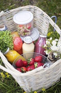 a basket filled with muffins and fruit next to another basket full of food