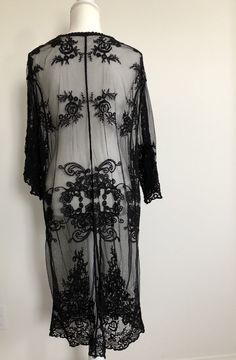 "Bohemian style sheer lace cardigan features a tie front and kimono style in a relaxed fit. It's beautifully made in delicate embroidered sheer lace all over. Can be dressed down or dress up -- made a romantic cover up for a summer night outing, a party, or just to the beach! ONE SIZE FITS MOST - SMALL, MEDIUM LARGE Length: 44\" Bust: 20\" (tie front, one size fits all) Sleeve length: 17\" Armhole : 11\"" Fitted Lace Cover-up With Lace Trim, Sheer Lace For Spring Party, Long Sleeve Lace Trim Beach Cover-up, Sheer Lace Cover-up For Spring, Sheer Long Sleeve Festival Cover-up, Elegant Fitted Long Sleeve Cover-up, Bohemian Lace Cover-up With Lace Patchwork, Spring Sheer Long Sleeve Kimono, Spring Lace Cover-up With Lace Trim