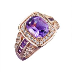 Our solid 925 sterling silver ring is lavishly fused with warm 18k Rose gold that is famous for flattering all skin tones. The Royal Purple of our 3.5 carats of our Cushion cut Amethyst centre stone works so will with this tone of gold to give a rich warm feel to the ring. A further 8 Amethysts are expertly channel set on the ring shoulders whilst 30 of our flawless lab Diamondeau® - the Supreme Diamond Alternatives circle the main stone and then filter down to the charming leaf designs on the s Luxury Rose Gold Rings With Accent Stones, Luxury Amethyst Rings With Halo Setting, Luxury Amethyst Halo Setting Promise Ring, Luxury Rose Gold Amethyst Ring With Center Stone, Luxury Amethyst Promise Ring With Halo Setting, Luxury Amethyst Ring With Halo Setting For Promise, Luxury Rose Gold Amethyst Ring, Luxury Rose Gold Amethyst Ring For Anniversary, Gold Amethyst Ring With Halo Setting, Fine Jewelry