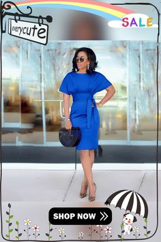 a woman in a blue dress is holding an umbrella and posing with her hands on her hips