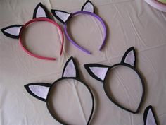 three cat ears made out of paper on a table