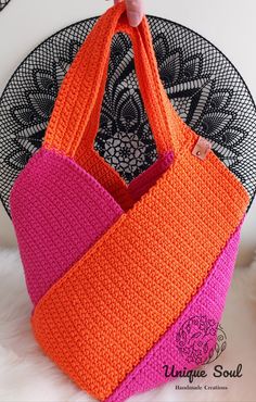 two crocheted bags sitting on top of a black doily next to an orange and pink bag