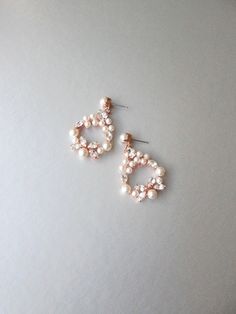 "These romantic, delicate dangling earrings are made with fine Swarovski crystals and Swarovski pearls. Available in gold or silver finish. Post back with butterfly ear-nuts. - Measurements : 2 \" long in total length and 1 1/4\" wide" Elegant Rose Gold Bridal Earrings With Sparkling Stones, Elegant Rose Gold Cluster Earrings For Party, Party Rose Gold Pearl Earrings With Cubic Zirconia, Elegant Rose Gold Cluster Earrings For Wedding, Elegant Jeweled Pearl Wedding Earrings, Elegant Jeweled Pearl Earrings For Wedding, Rose Gold Cubic Zirconia Dangle Pearl Earrings, Rose Gold Pearl Bridal Earrings For Anniversary, Rose Gold Pearl Earrings For Wedding