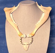 This Artisan Bone Beads necklace features: Themes: Protection; Connection With the Ancestors; LIGHTWEIGHT This strandis about 21" Inside Diameter (measurement of the part closest to your neck, not counting drops and focal beads though this one is tricky to assign a value) and features: Mule Deer Jawbones (matched, from same deer) Bone Beads African Brass Cicone spacer beads This is a part of my Artisan Collection and is a One of a Kind creation! #ooakjewelry #shaman #ooaknecklace #soundhealing # Bone Clothes, Bone Jewellery, Bone Fashion, Real Bone Jewelry, Animal Bone Jewelry, Bone Accessories, Bone Bead Necklace, Leg Bones, Bone Crafts