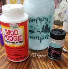 two jars with happy camper on them sitting on a table next to each other