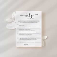 a baby shower checklist with leaves on the side and a white sheet that says, baby